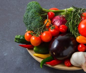 high-angle-view-bunch-tomatoes-with-chili-peppers-onion-eggplant-greens-broccoli-garlic-gray-surface-horizontal_176474-5104